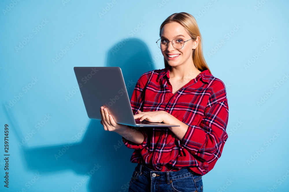 Portrait of nice charming cute attractive winsome cheerful cheery teen girl wearing checked shirt holding in hands laptop isolated on teal turquoise bright vivid shine background Portrait of nice charming cute attractive winsome cheerful cheery teen girl wearing checked shirt holding in hands laptop isolated on teal turquoise bright vivid shine background