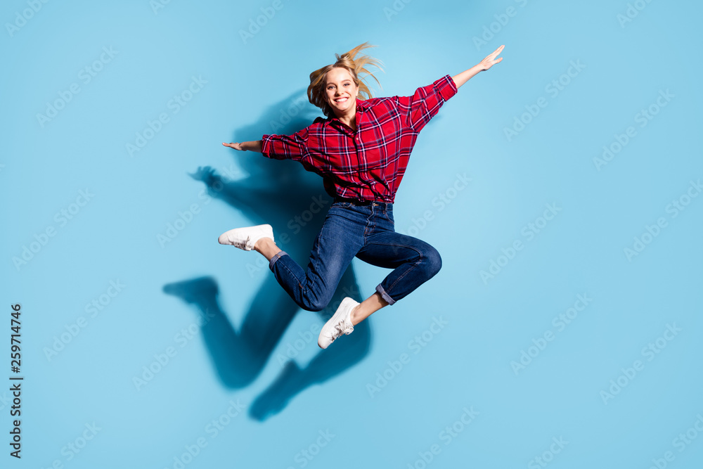 Full length body size view portrait of nice charming cute attractive cheerful cheery teen girl wearing checked shirt flying like plane isolated on teal turquoise bright vivid shine background
