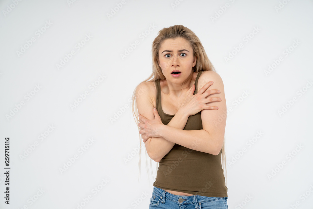 Young attractive girl is scared and very surprised. Isolated on white background Young attractive girl is scared and very surprised. Isolated on white background