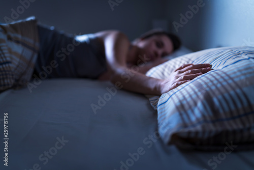 Foto Single woman sleeping alone in bed at home
