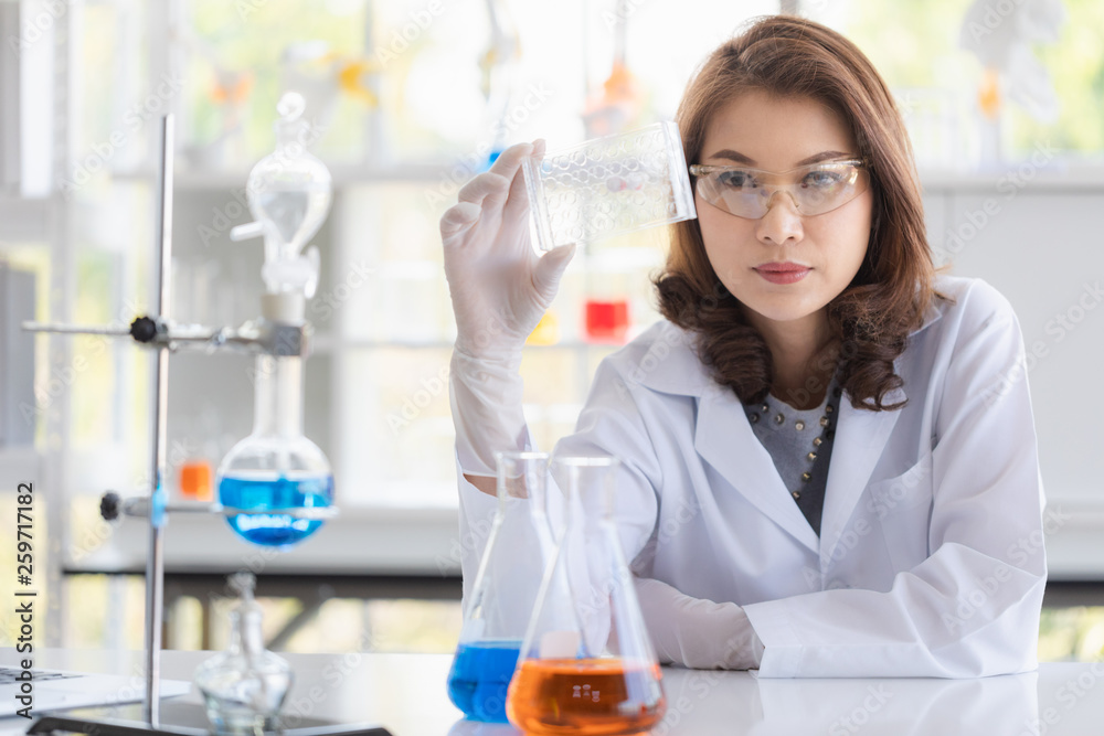 Scientist holding test tube tray in her hand.. Scientist holding test tube tray in her hand..