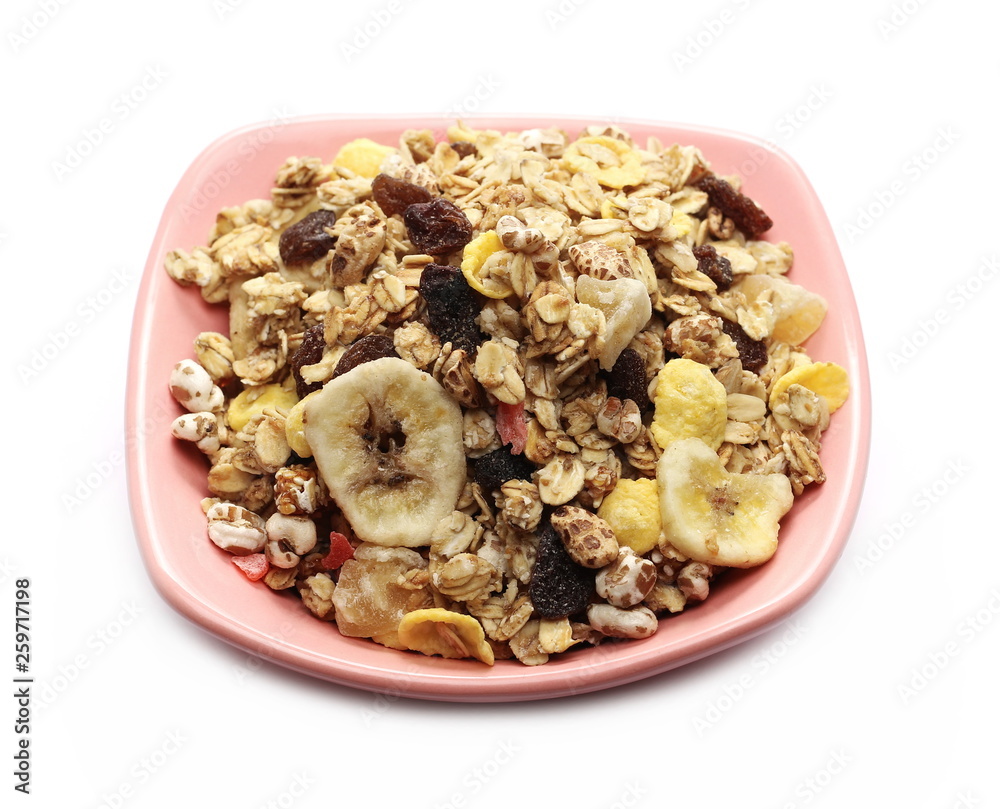 Crunchy tropical muesli pile mix with banana, pineapple, papaya slices and raisins in bowl isolated on white background Crunchy tropical muesli pile mix with banana, pineapple, papaya slices and raisins in bowl isolated on white background