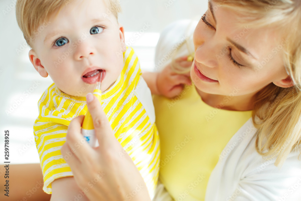 Mom baby brushing teeth