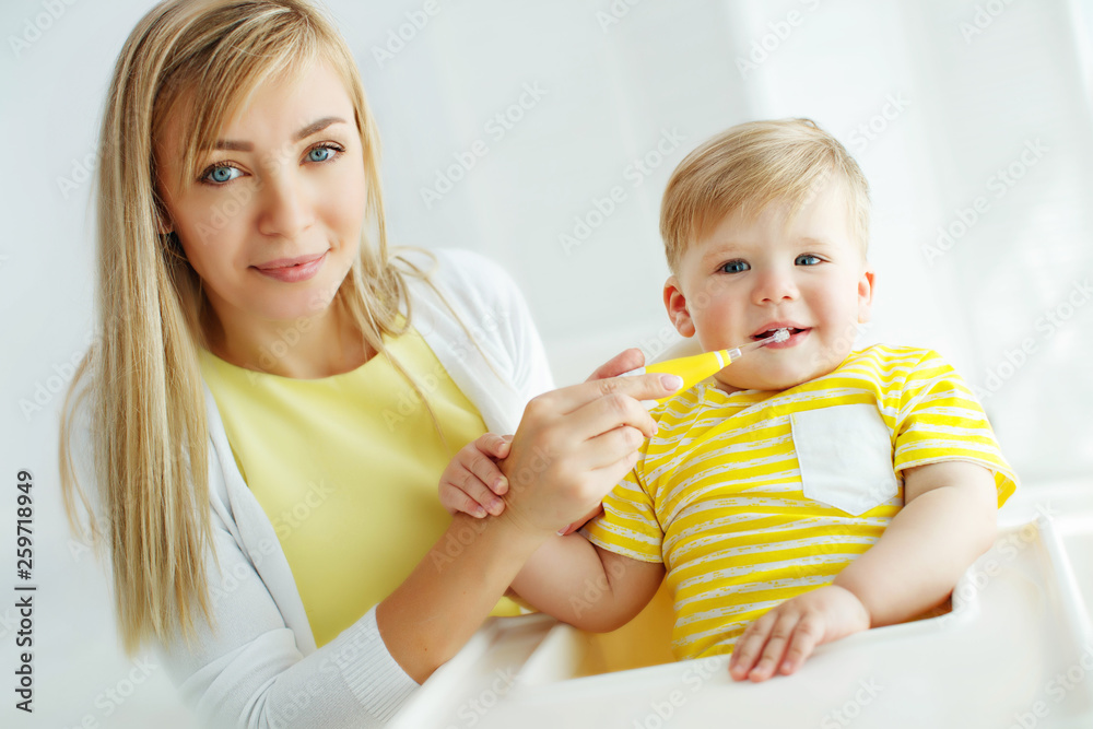 Mom baby brushing teeth