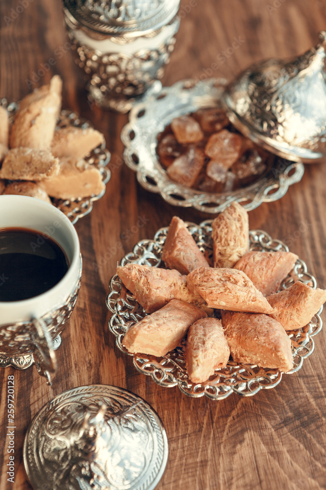Fototapeta premium Turkish sweets with coffee on a wooden table