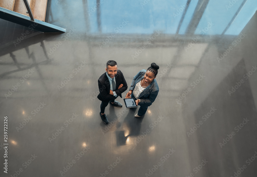 custom made wallpaper toronto digitalTwo business people standing in the lobby of an office looking up smiling at the camera while