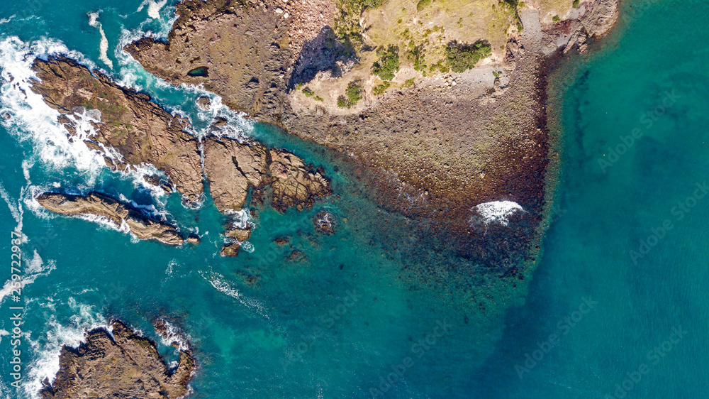 aerial shot of waves hitting rocks aerial shot of waves hitting rocks