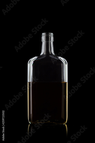 Bottle of whiskey rectangular shape, isolated on a black background with reflections. 100 sharpness.