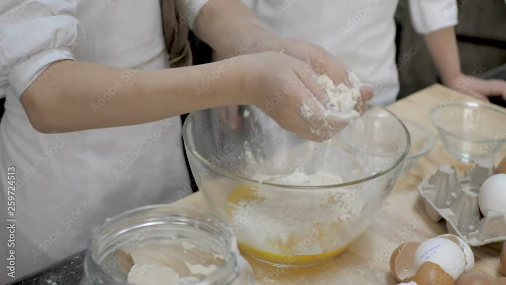 Girl kid are preparing the dough in the kitchen Girl kid are preparing the dough in the kitchen