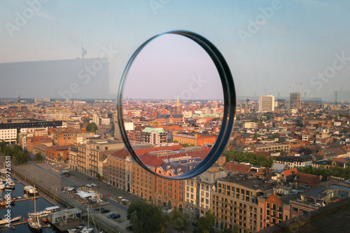 Cityscape of Antwerp, Belgium seen through a hole in a glass front made for photographers