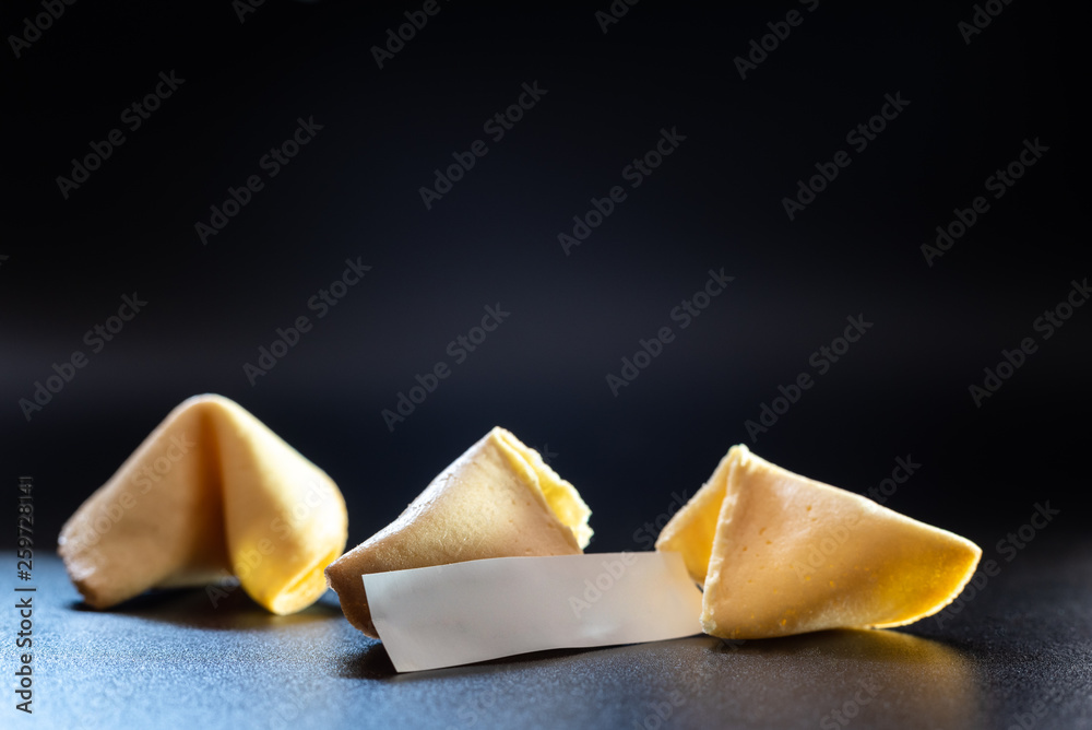 Lucky cookies broken with message of fortune, isolated on black background with empty space for text. Lucky cookies broken with message of fortune, isolated on black background with empty space for text.