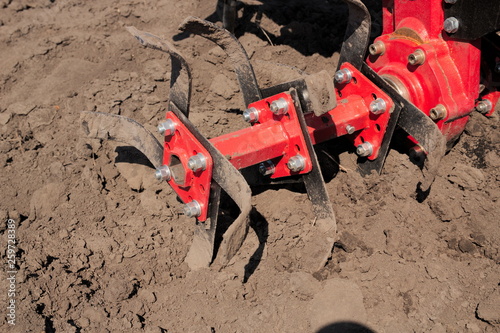 Foto Garden tiller for cultivating field, loosens soil