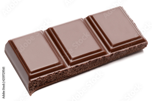 Dark organic chocolate pieces isolated on white background
