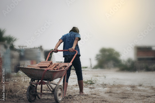 Child labor in building commercial building structures. World Labor Day concept photo