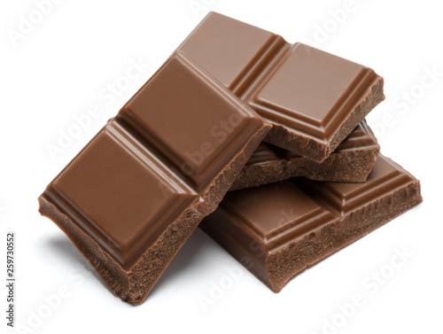 Milk organic chocolate pieces isolated on white background