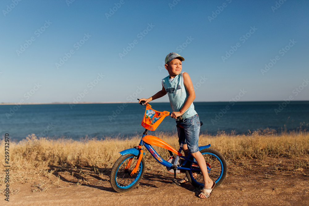 Portrait of a boy on the beach with his bicycle. Portrait of a boy on the beach with his bicycle.