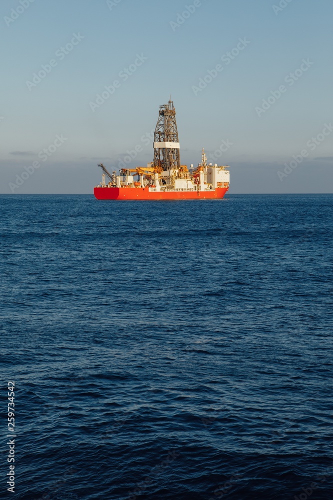 offshore oil and gas drillship, blue ocean background offshore oil and gas drillship, blue ocean background
