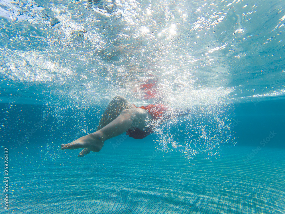 Girls are enjoying swimming in the pool with trees in the evening. Girls are enjoying swimming in the pool with trees in the evening.