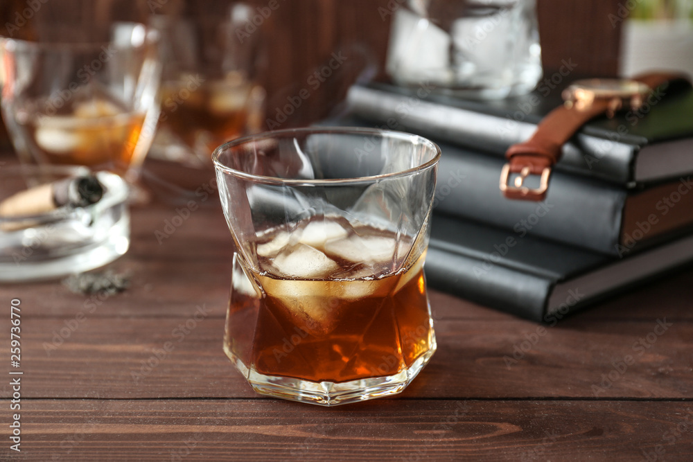 Glass of cold whiskey on wooden table Glass of cold whiskey on wooden table