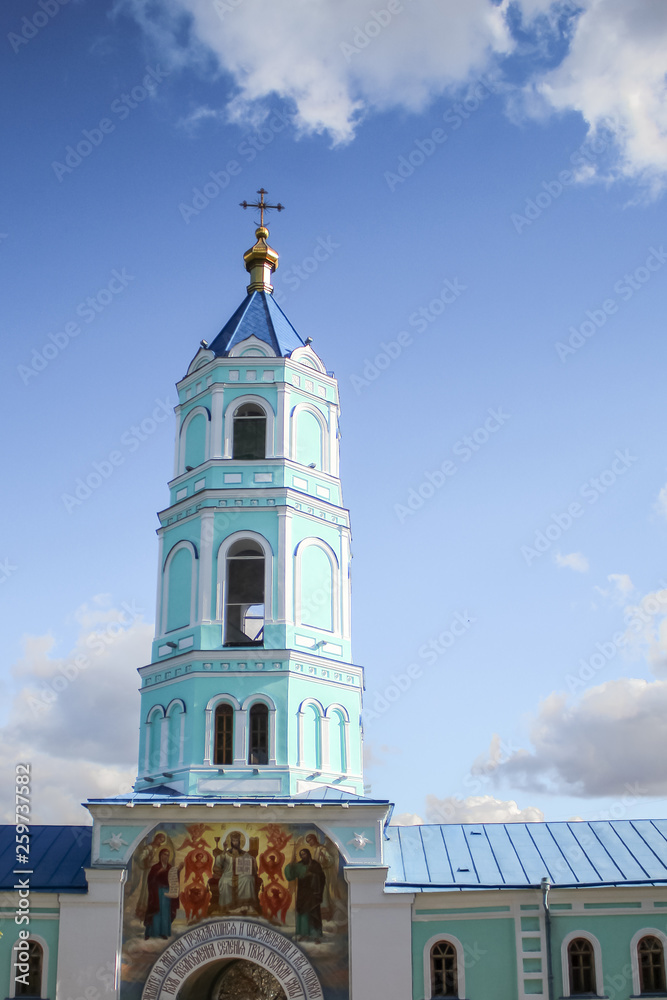 Obraz premium Belfry on the background of beautiful clouds
