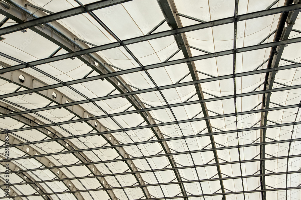 Part of the semicircular roof of a modern building. The ceiling in the hangar, shopping, sports or industrial building. Texture background. Part of the semicircular roof of a modern building. The ceiling in the hangar, shopping, sports or industrial building. Texture background.