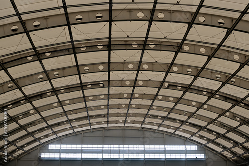 Domed roof of a modern building. Semicircular ceiling in the hangar, sports or industrial building. Copy space.
