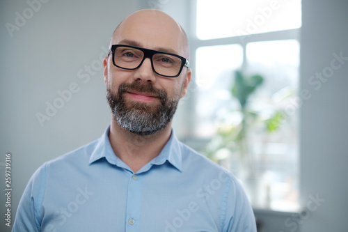 Bearded middle-aged man wearing glasses.