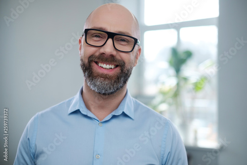 Bearded middle-aged man wearing glasses.