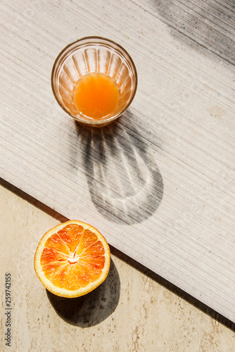 Refreshment drinks on astone table. Summer tropical mood with artistic geometric shadows. Still life and lifestyle concept in retro style. photo