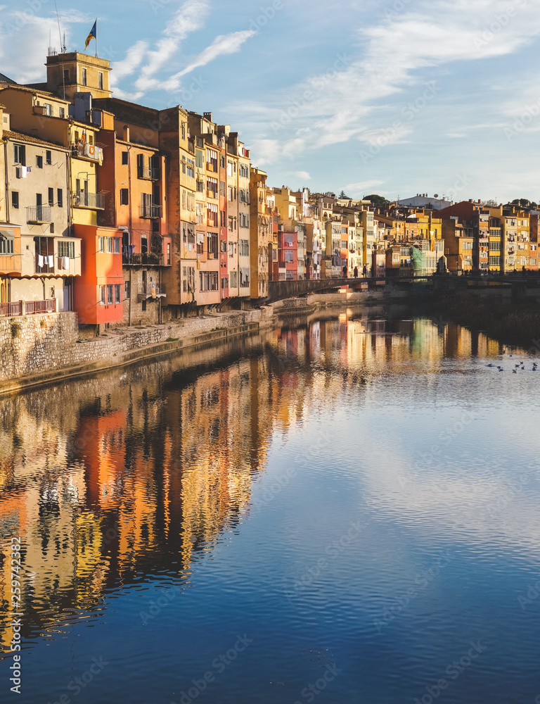 Houses in Girona reflected in the river Onyar on a summer day
