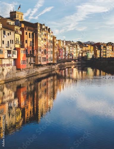 Houses in Girona reflected in the river Onyar on a summer day