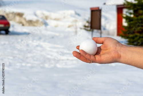 round snowball in outstretched hand