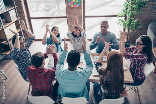 Cheerful coworkers guys partners race clapping hands applauding having aims celebrating professional in casual shirts in nice boardroom office