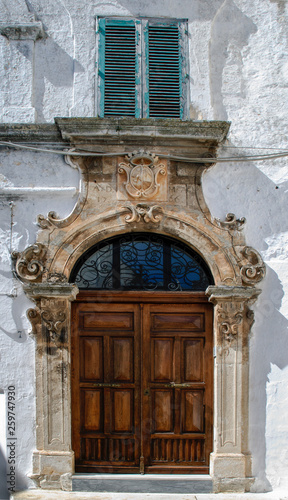 Facade of old building with magnificent door in the old town of Ostuni, La Citta Bianca