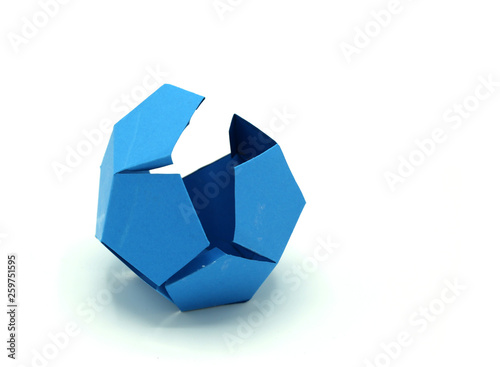 Geometric shape cut out of Blue paper and photographed on white background.Dodecahedron. 2d shape foldable to form a 3d shape or a solid.