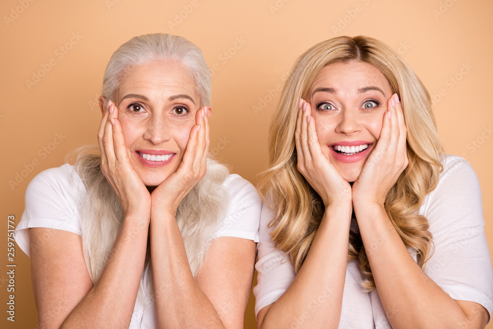 Close-up portrait of nice-looking winsome lovely attractive charming cheerful cheery ladies wearing white t-shirt showing delight expression isolated over beige pastel background Close-up portrait of nice-looking winsome lovely attractive charming cheerful cheery ladies wearing white t-shirt showing delight expression isolated over beige pastel background