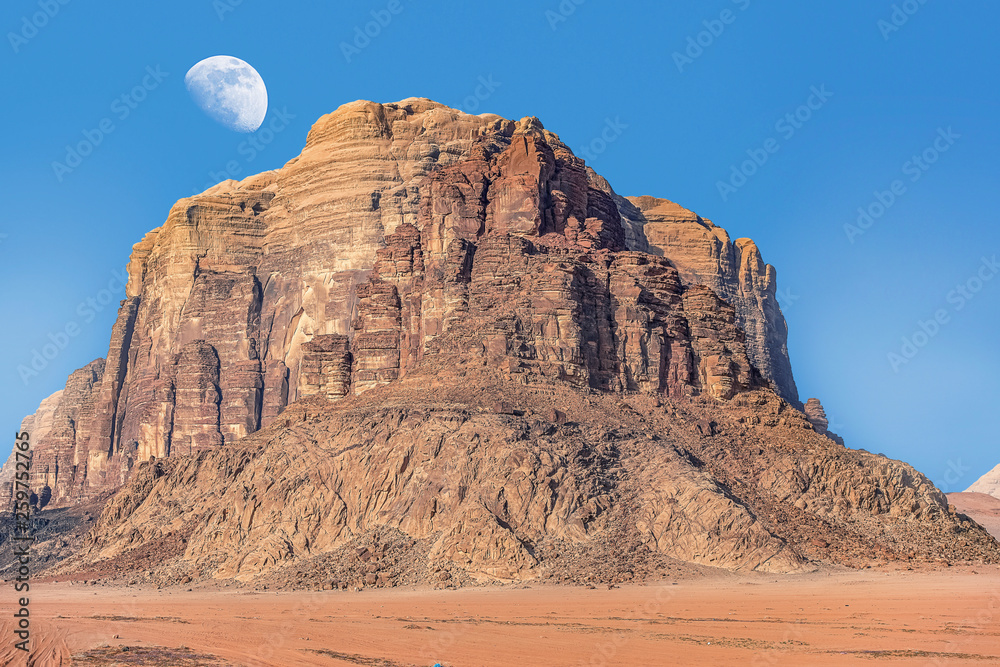 Fototapeta premium incredible lunar landscape with huge moon in Wadi Rum village in the Jordanian red sand desert. Wadi Rum also known as The Valley of the Moon, Jordan - Image