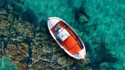 Photos Aerial photo from traditional picturesque fishing boat on turquoise clear sea as