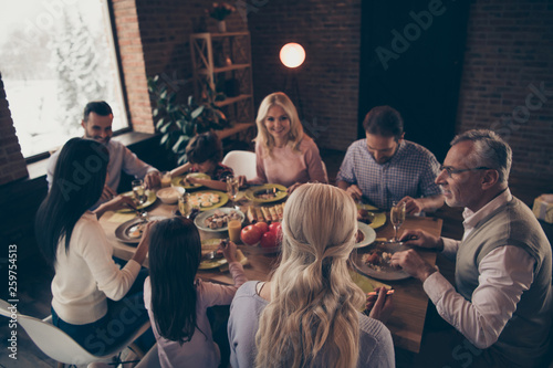 Close up photo big large family thanksgiving conversation talk chat members brother sister granny mom dad grandpa little son daughter sitting round festive holiday tasty dishes table loft house
