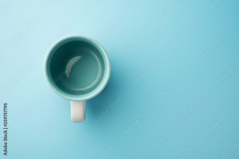 Fototapeta premium Empty glass cup milk or coffee isolated on blue background food drink object design