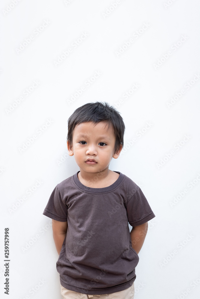 Portrait of a toddler boy wearing grey T-shirt on white background Portrait of a toddler boy wearing grey T-shirt on white background