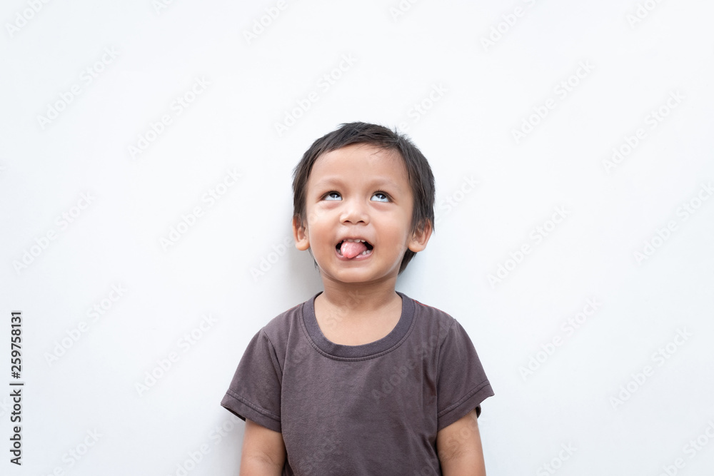 Portrait of a toddler boy making funny face and sticking out his tongue on white background Portrait of a toddler boy making funny face and sticking out his tongue on white background
