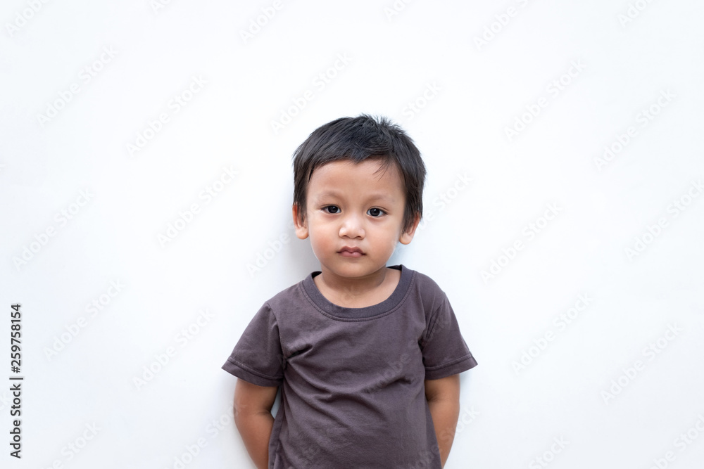 Portrait of a toddler boy wearing grey T-shirt on white background Portrait of a toddler boy wearing grey T-shirt on white background