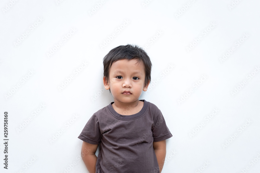 Portrait of a toddler boy wearing grey T-shirt on white background Portrait of a toddler boy wearing grey T-shirt on white background