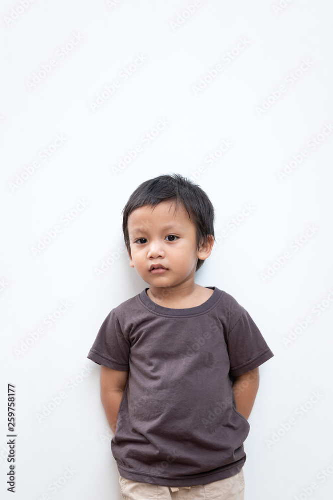 Portrait of a toddler boy wearing grey T-shirt on white background Portrait of a toddler boy wearing grey T-shirt on white background