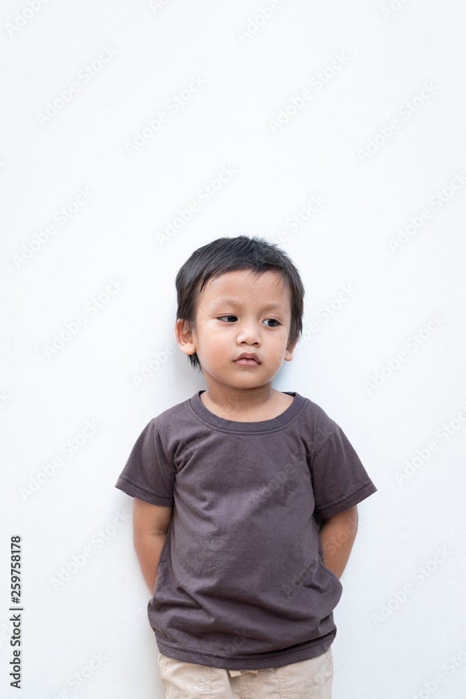 Portrait of a toddler boy wearing grey T-shirt on white background Portrait of a toddler boy wearing grey T-shirt on white background