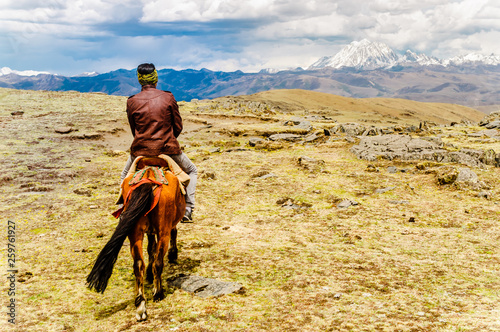 View on nomade on horse in the highlands of Sichuan