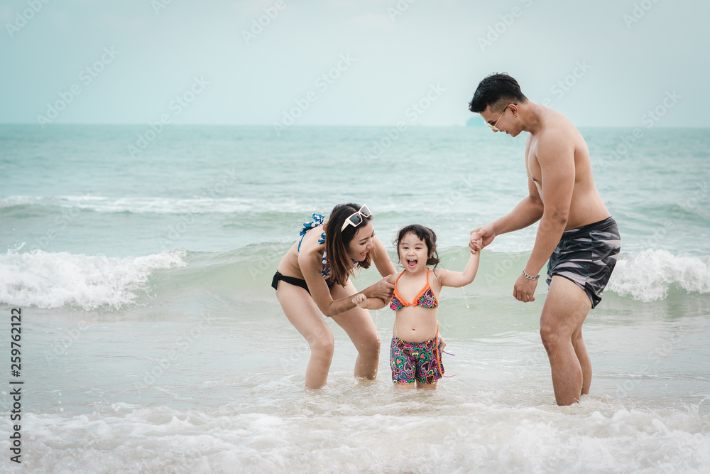 Happy family father, mother and child having fun on blue sea tropical beach..Summer holiday traval concept.