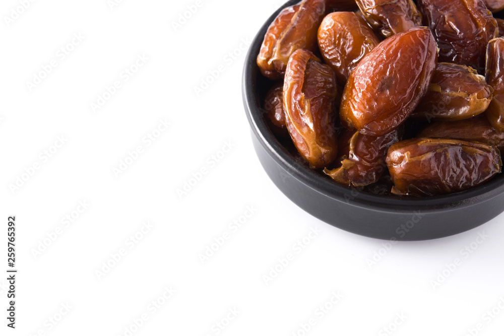 Dates in black bowl isolated on white background. Copyspace Dates in black bowl isolated on white background. Copyspace
