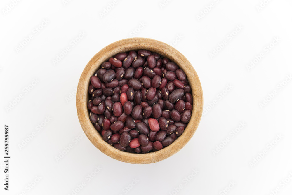 red beans in a wooden plate on a white background red beans in a wooden plate on a white background